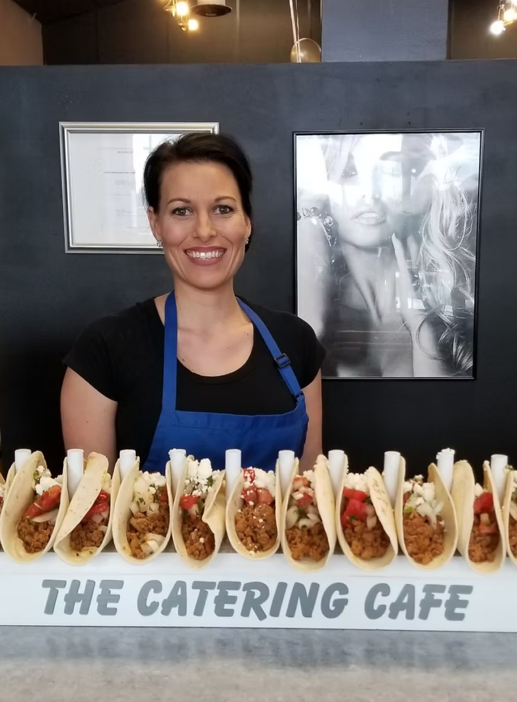 Jessica standing in front of Tacos from the Catering Cafe